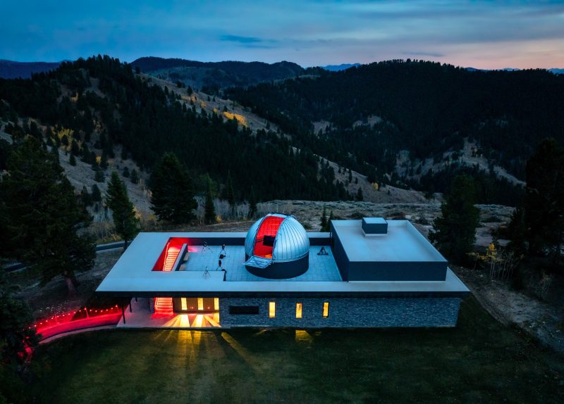 Snow King Observatory with telescopes looking to mountains, during sunset.